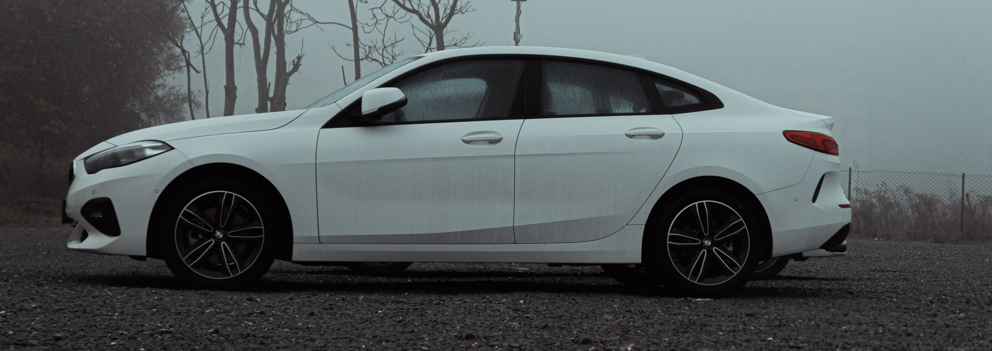 Side view of a white car with tappable areas
